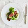 Slice of lamb shank on a bed of barley with fresh greens | Shop Sabato Auckland